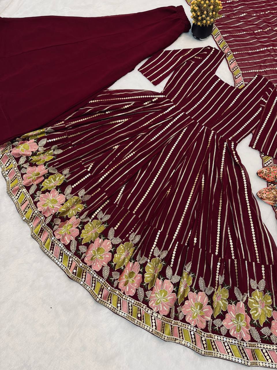 Majestic Maroon Flared Anarkali Suit Set Adorned with Luminous Sequin Stripes and an Ornate Floral Embroidered Hemline